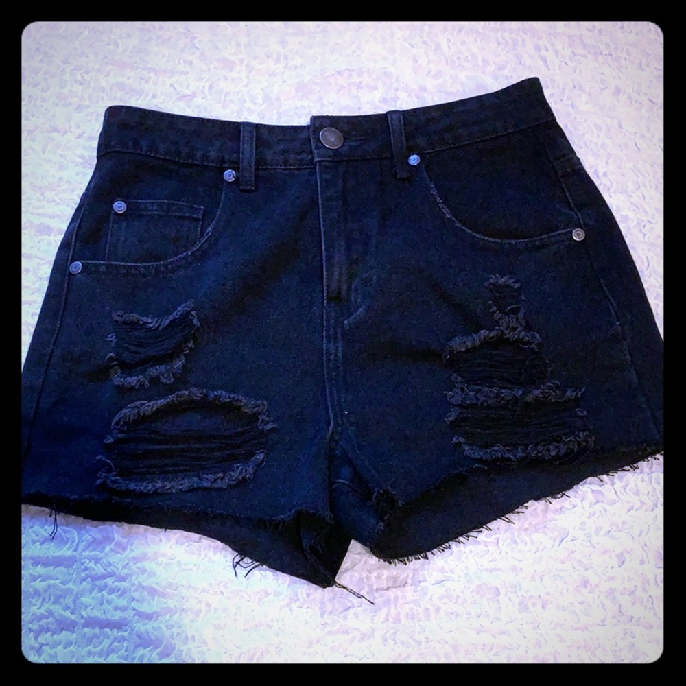 High waisted distressed black denim shorts.